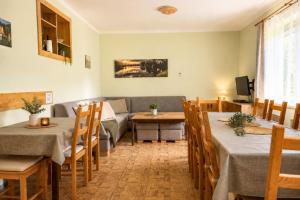 a living room with tables and a couch at Chata Bystřička in Velká Lhota