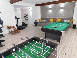 a living room with a pool table in the middle at Del Mar 2 in Kampor
