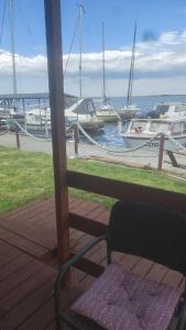 a porch with a view of a marina with boats at Domki letniskowe 30m2 in Nowe Warpno