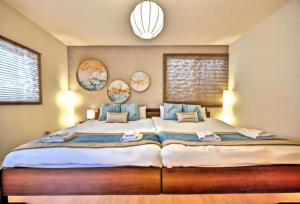 a bedroom with a large bed with blue pillows at Tsukiyume Kan - Entire Private House, Free Parking, 10min USJ & Tennoji, Airport Direct Train, Family Group Sleeps 8, 和モダン貸切一軒家 ユニバーサルスタジオ in Osaka