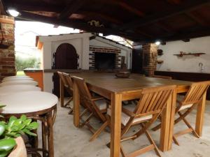 a wooden dining table and chairs in a room at Del Mar 2 in Kampor