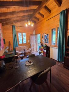 a living room with a table in a wooden house at La Baita di Lusso Bagnone in Bagnone