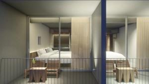 a balcony with a room with a bed and a table and chairs at Rucha Beachfront Retreat in Ấp An Lộc A