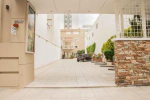 an empty street with a car parked in a building at Hotel Selent in Mar del Plata +15 photos