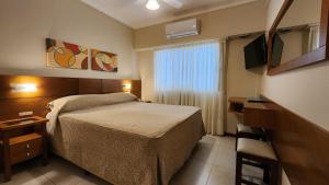 a hotel room with a bed and a window at Hotel Selent in Mar del Plata