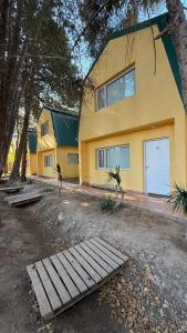 a yellow house with a fence in front of it at Los Nogales de Tatash in Centenario