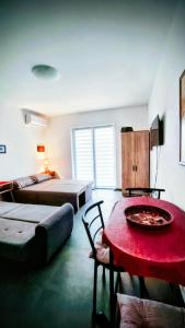 a bedroom with a bed and a table with a red table at Apartman DimDam in Veliko Gradište