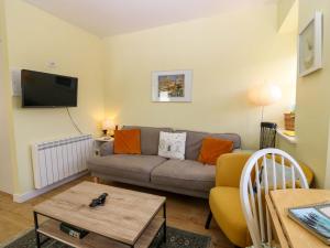 a living room with a couch and a table at Lightkeepers Fold in Eyemouth