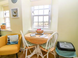 a dining room with a table and chairs at Lightkeepers Fold in Eyemouth