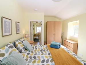 a bedroom with a bed with a blue bag on it at Lightkeepers Fold in Eyemouth