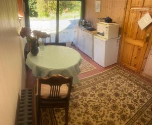 a small kitchen with a table and a refrigerator at Sanctuary Apartment nestled in nature in Westport