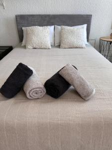 a bed with two towels and pillows on it at Appartement Standing proche des Thermes in Vichy