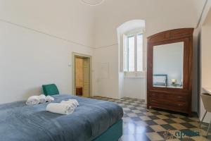 a bedroom with a bed with towels on it at Villa Stone and Sea Escape by Apulia Accommodation in Cozze