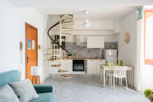 a living room with a blue couch and a table at Mimì sul Mare in Massa Lubrense