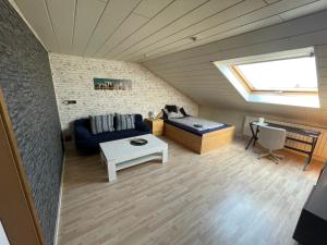 a living room with a couch and a table at Ferienwohnung in Weilburg in Weilburg