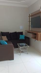 a living room with a couch and a tv at Casa Melcon in Aquiraz