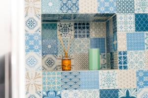 a bathroom with blue and white tiles and a mirror at Mimì sul Mare in Massa Lubrense +203 photos