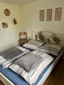 a bed with two pillows on it in a bedroom at Heckenstübchen in Simmerath