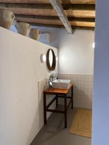 a bathroom with a sink and a mirror at Monte da Palmeira in Vila Nova da Baronia +27 photos