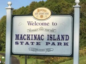 a welcome sign for a margaya island state park at Above Mustang Condos in Mackinac Island