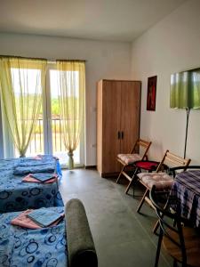 a bedroom with two beds and a table and chairs at Apartman DimDam in Veliko Gradište