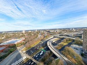 an aerial view of a city with traffic on a highway at Ember Sky Penthouse in Atlanta