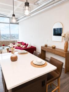 a living room with a table and a couch at Ember Sky Penthouse in Atlanta