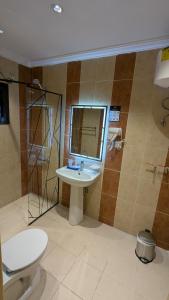 a bathroom with a sink and a shower and a toilet at أمكو للشقق المخدومة in Jeddah +40 photos