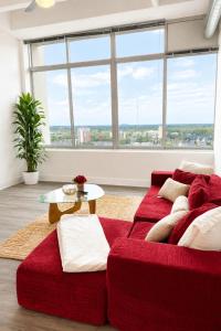 a living room with a red couch and a table at Ember Sky Penthouse in Atlanta