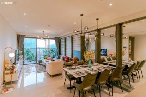 a dining room with a long table and chairs at ChiHome Metropole The Opera Residence Luxury in Ho Chi Minh City