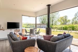 a living room with two couches and a fireplace at 2 Bed in Colchester oc-82397 in East Bergholt