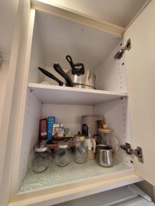 a cupboard filled with lots of kitchen items at Chios Flower House in Agia Ermioni
