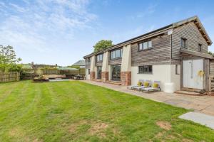 a house with a lawn in front of it at 5 Bed in Tiverton oc-48151 in Cadeleigh