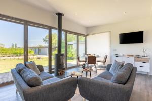 a living room with two couches and a fireplace at 2 Bed in Colchester oc-82399 in East Bergholt