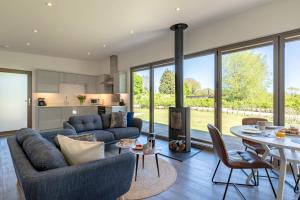 a living room with a couch and a table at 2 Bed in Colchester oc-82399 in East Bergholt