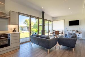 a kitchen and living room with two couches and a table at 2 Bed in Colchester oc-82399 in East Bergholt +11 photos