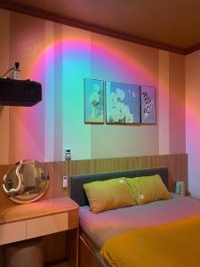 a bedroom with a bed and a rainbow wall at ChillDate in Bắc Ninh