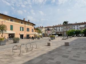 a square with benches in a city with buildings at Lemon House in Stezzano