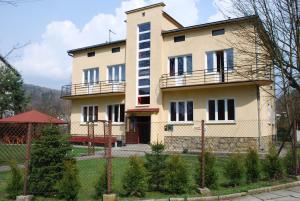 a large house with a fence in front of it at Bukowianka in Muszyna