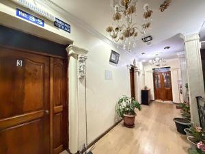 a hallway of a building with a chandelier at Hostal Atlantis Middle World in Quito