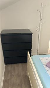 a bedroom with a bed and a black dresser at Apartment Barba in Bribir +6 photos