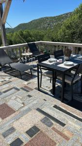 a patio with a table and chairs on a patio at Apartment Barba in Bribir