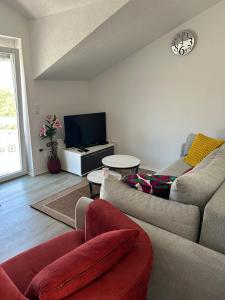 a living room with a couch and a tv at Apartment Barba in Bribir