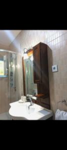 a bathroom with a sink and a mirror at Rafailovici Sea View in Rafailovici