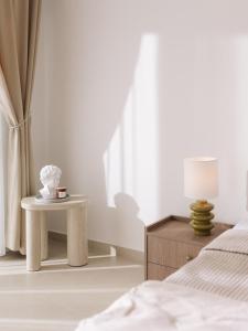 a bedroom with a bed and a table with a lamp at NUA Apartments in Ulcinj