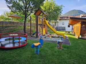 a playground with different types of play equipment in a yard at Falgerhof in Vollan