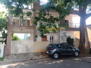 a small car parked in front of a building at Trayi stay in Mysore
