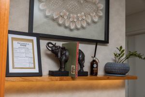 a shelf with a book and a statue on it at Stylish Luxury Apartment - Fully Equipped in Asunción