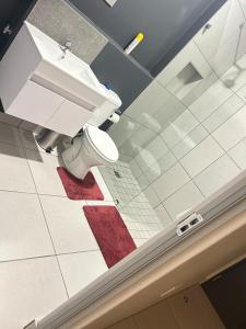 a bathroom with a toilet and a sink at Elisa's Haven in Matsulu