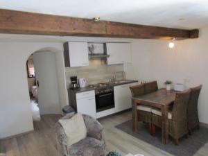 a kitchen with a table and a dining room at Sabershausen Landhof Sonne in Sabershausen